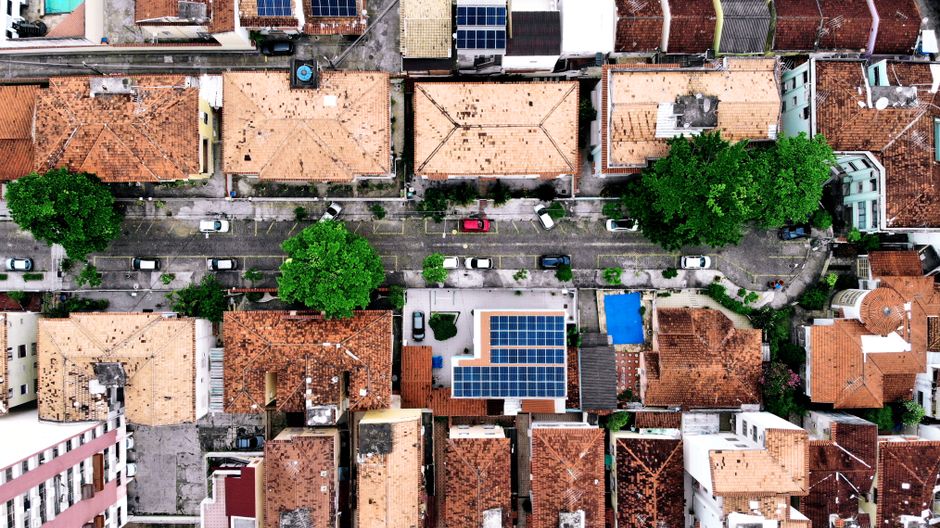 Top-down aerial shot of residential area with solar panels in Rio de Janeiro, Brazil.